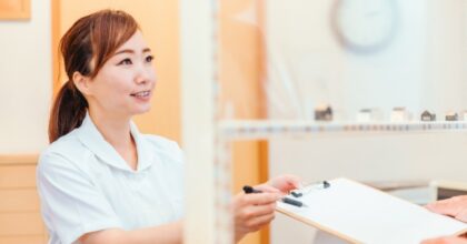 受付で書類を手渡すスタッフ
